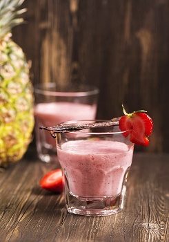 Fresh healthy strawberry and pineapple smoothie with vanilla. Toned image